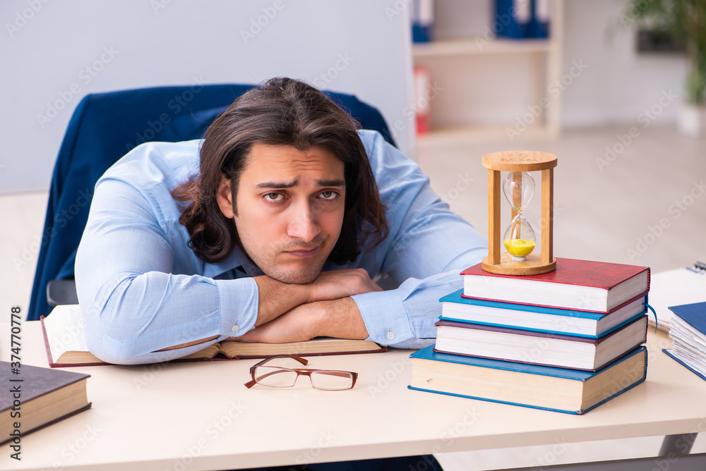 Young businessman student in time management concept Young businessman student in time management concept