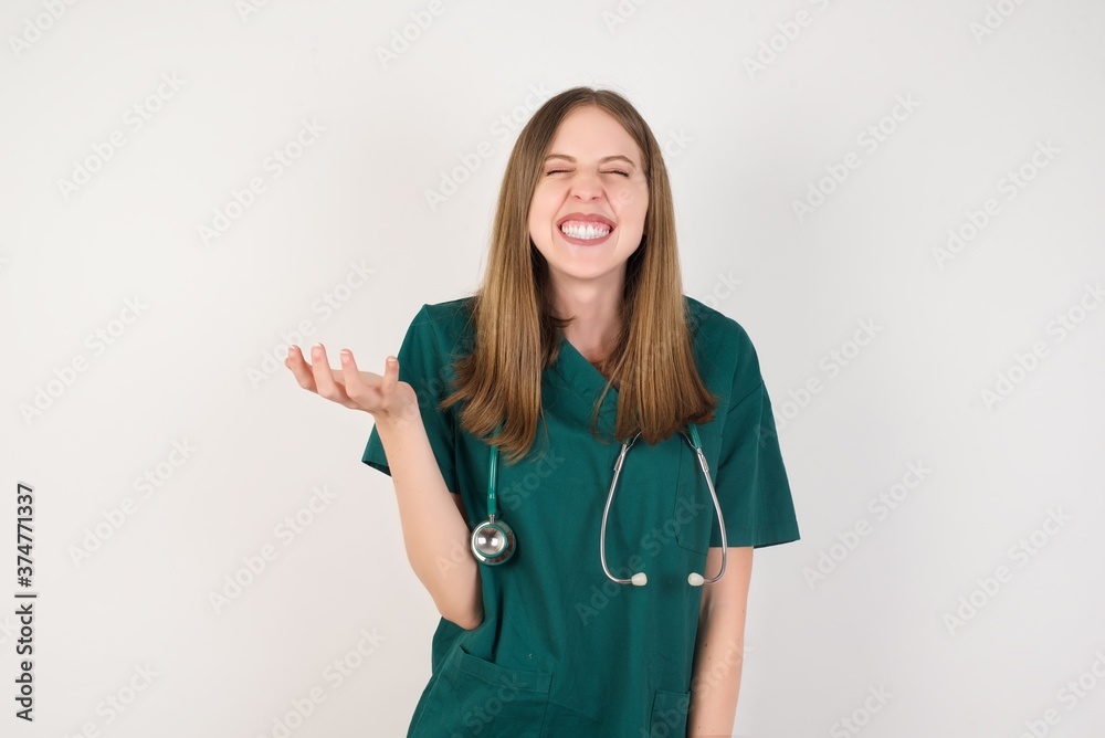 Female doctor wearing a green scrubs and stethoscope very happy and excited about new plans. Female doctor wearing a green scrubs and stethoscope very happy and excited about new plans.