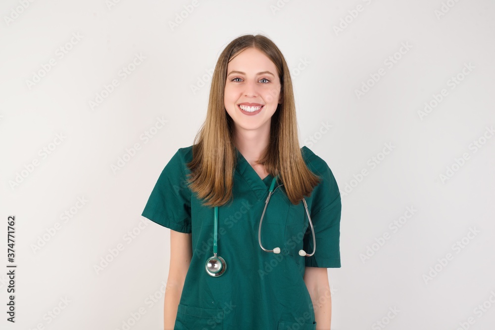Female doctor wearing a green scrubs and stethoscope with a happy and cool smile on face. Lucky person. Female doctor wearing a green scrubs and stethoscope with a happy and cool smile on face. Lucky person.