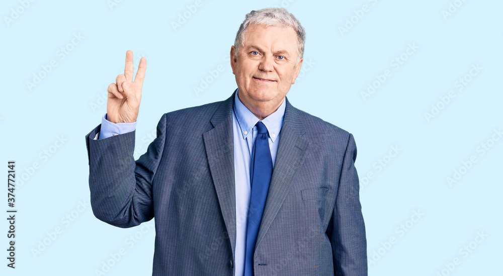 Senior grey-haired man wearing business jacket smiling looking to the camera showing fingers doing victory sign. number two. Senior grey-haired man wearing business jacket smiling looking to the camera showing fingers doing victory sign. number two.
