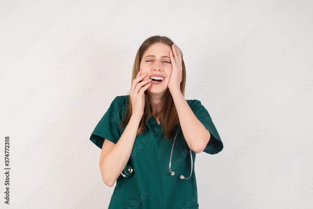 Doleful desperate crying Female doctor wearing a green scrubs being in depression after quarrel with wife or girlfriend, looks stressfully, frowns face, . Handsome male feels lonely and anxious Doleful desperate crying Female doctor wearing a green scrubs being in depression after quarrel with wife or girlfriend, looks stressfully, frowns face, . Handsome male feels lonely and anxious