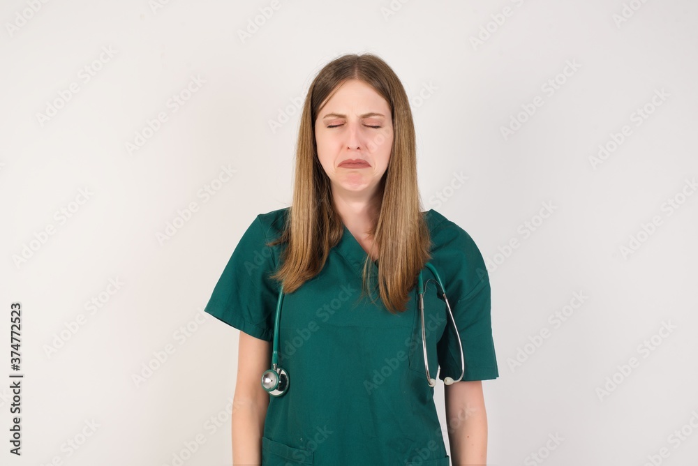Dismal gloomy rejected Female doctor has problems and difficulties, curves lower lip and closes eyes in despair, being in depression after desperate attempts to become participant of fashion show Dismal gloomy rejected Female doctor has problems and difficulties, curves lower lip and closes eyes in despair, being in depression after desperate attempts to become participant of fashion show