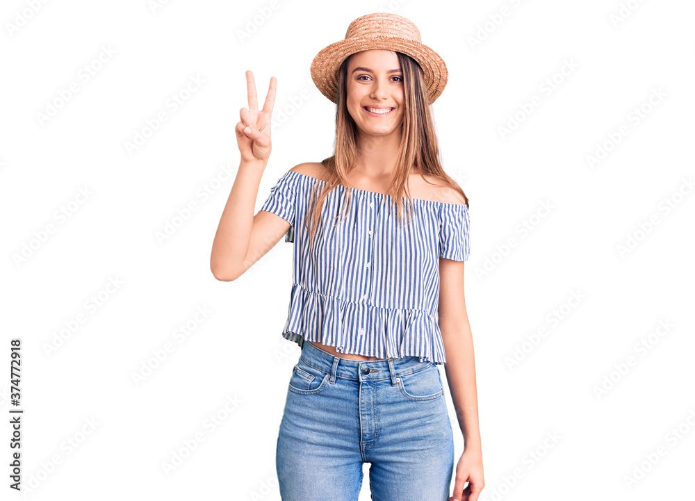 Young beautiful girl wearing hat and t shirt showing and pointing up with fingers number two while smiling confident and happy. Young beautiful girl wearing hat and t shirt showing and pointing up with fingers number two while smiling confident and happy.