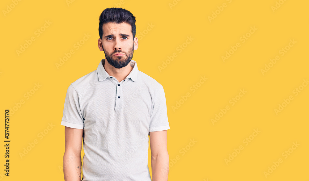 Young handsome man with beard wearing casual polo depressed and worry for distress, crying angry and afraid. sad expression. Young handsome man with beard wearing casual polo depressed and worry for distress, crying angry and afraid. sad expression.