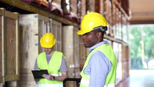 Multi ethnic warehouse workers (Caucasian, Black, African) in cargo