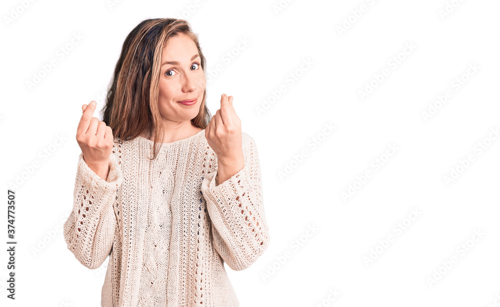 Young beautiful blonde woman wearing casual sweater doing money gesture with hands, asking for salary payment, millionaire business Young beautiful blonde woman wearing casual sweater doing money gesture with hands, asking for salary payment, millionaire business