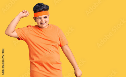 Little boy kid wearing sportswear dancing happy and cheerful, smiling moving casual and confident listening to music