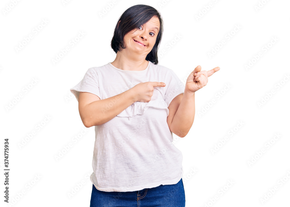 Brunette woman with down syndrome wearing casual white tshirt pointing aside worried and nervous with both hands, concerned and surprised expression Brunette woman with down syndrome wearing casual white tshirt pointing aside worried and nervous with both hands, concerned and surprised expression
