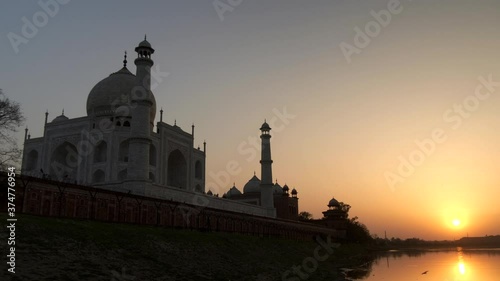 zoom in shot at sunset of the taj mahal and yamuna river in agra, india photo