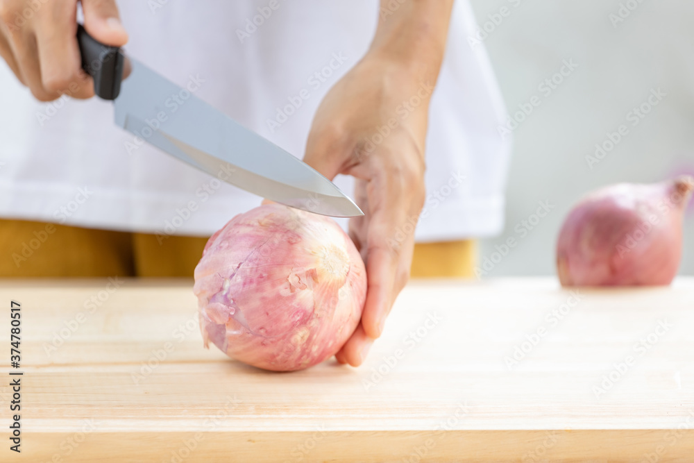 Big onion and slices on wooden cutting board