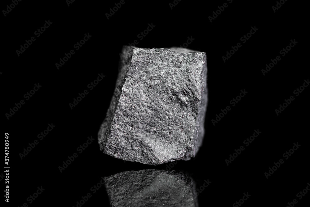 Magnetit ore, raw rock on black background, mining and geology Magnetit ore, raw rock on black background, mining and geology