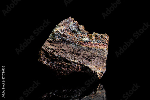 Limonite or brown iron ore, raw rock on black background, mining and geology