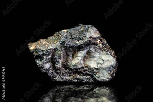 Stannite, tin and copper iron ore, raw rock on black background, mining and geology photo