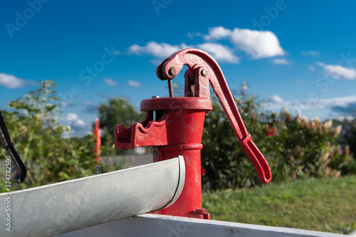 Old water pump from metal manual pump iron photo