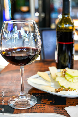 red wine glass bottle service romantic table in a cafe restaurant