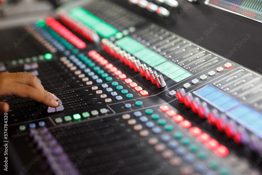 digital sound mixing console with hand on faders