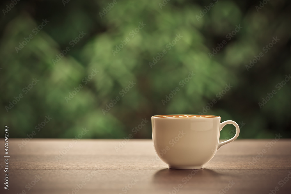Hot coffee, Latte art on cappuccino coffee cup, with beautiful nature background.