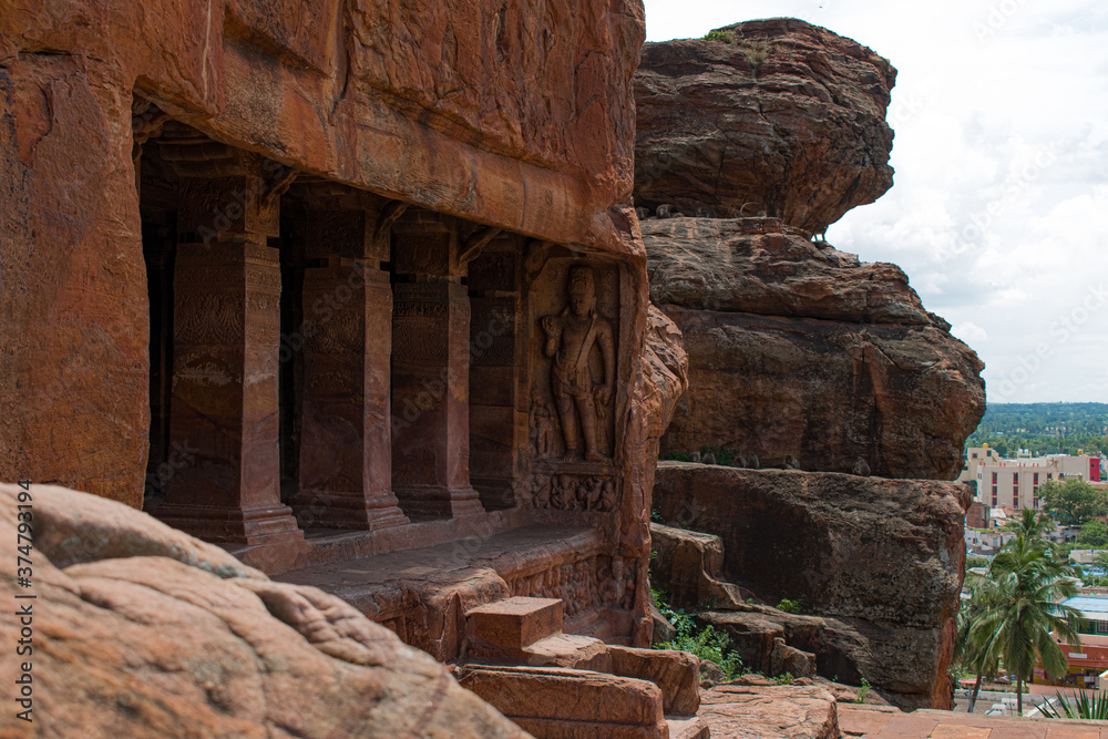 Ancient stone pillars carving inside a single red sandstone Rocky mountain, having old indian architecture.