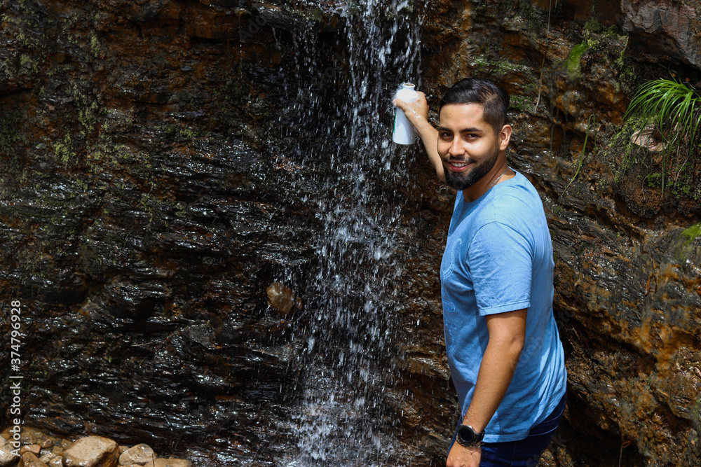 Fototapeta premium young man in the waterfall