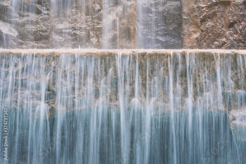 landscape of beautiful Artificial waterfall in garden at the public park