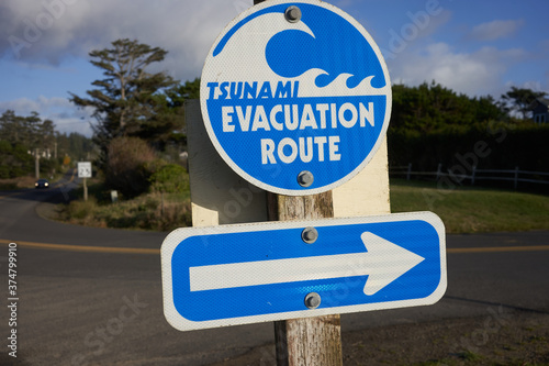 Closeup of the tsunami evacuation route directional sign on a coastal neighborhood street in Oregon, northwestern United States.