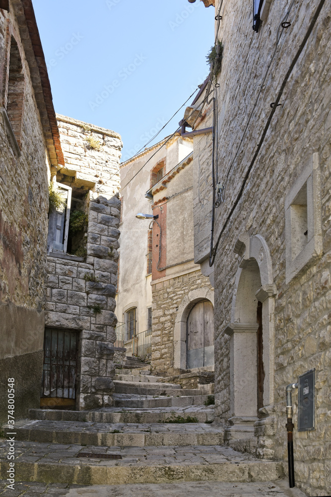 Fototapeta premium A narrow street among the old houses of Cercemaggiore, a medieval village in the Molise region.