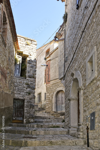 Fototapeta Naklejka Na Ścianę i Meble -  A narrow street among the old houses of Cercemaggiore, a medieval village in the Molise region.