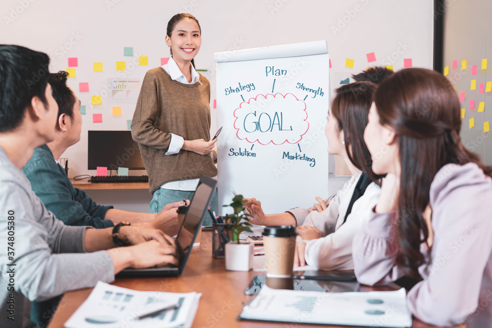 Obraz premium Focus on young asian businesswoman presenting the work,people group have discussion meeting in office.Man and woman have communication brainstorming and working.Business Startup Diversity Concept