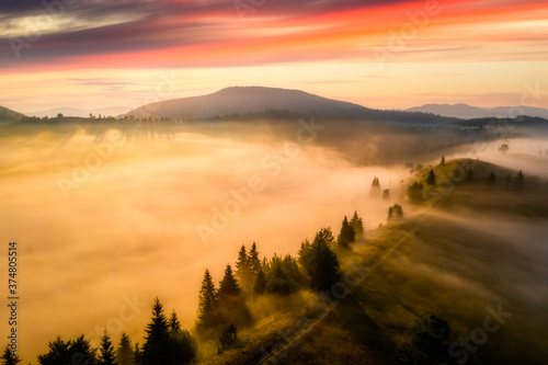 Fog in the mountains at dawn. Beautiful summer foggy landscape. Hiking in the mountains