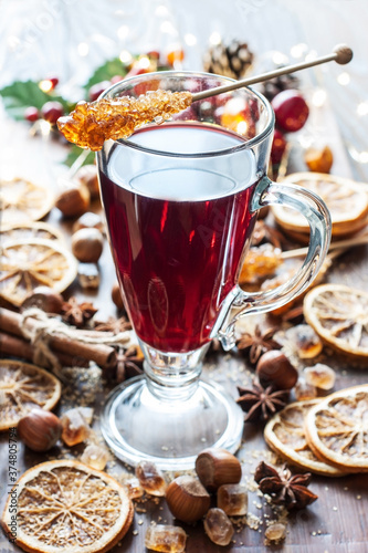 Glass with mulled wine and spices, close up