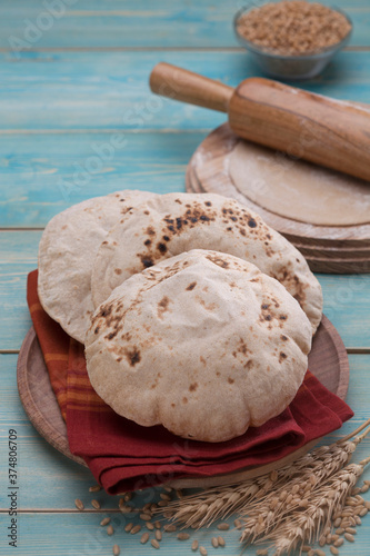 Indian bread (Roti) on a wooden base along with the props.