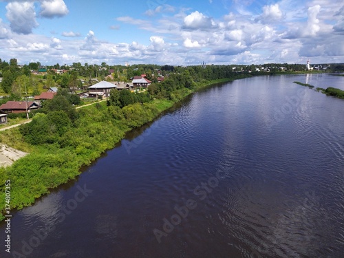 View of a small Russian town Totma and wide calm river from a high bridge