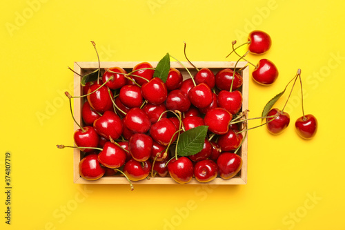 Tray with sweet cherry on color background