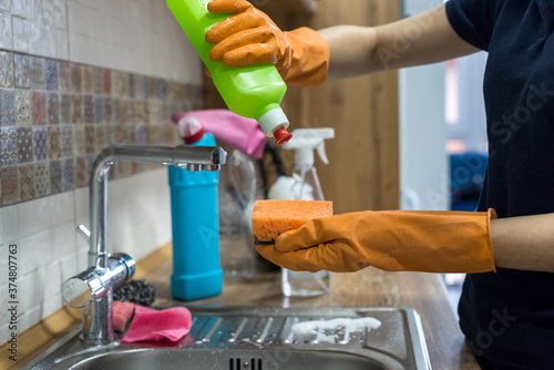  woman holding cleaning products and products and ready to clean