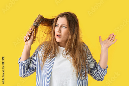 Stressed woman brushing hai...