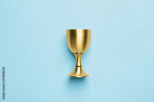 Sacramental goblet for wine on color background. Rosh hashanah (Jewish New Year) celebration photo