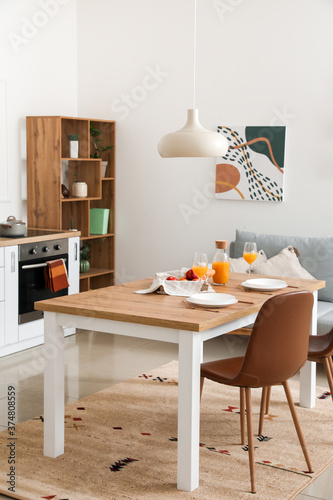 Interior of modern stylish kitchen with dining table © Pixel-Shot