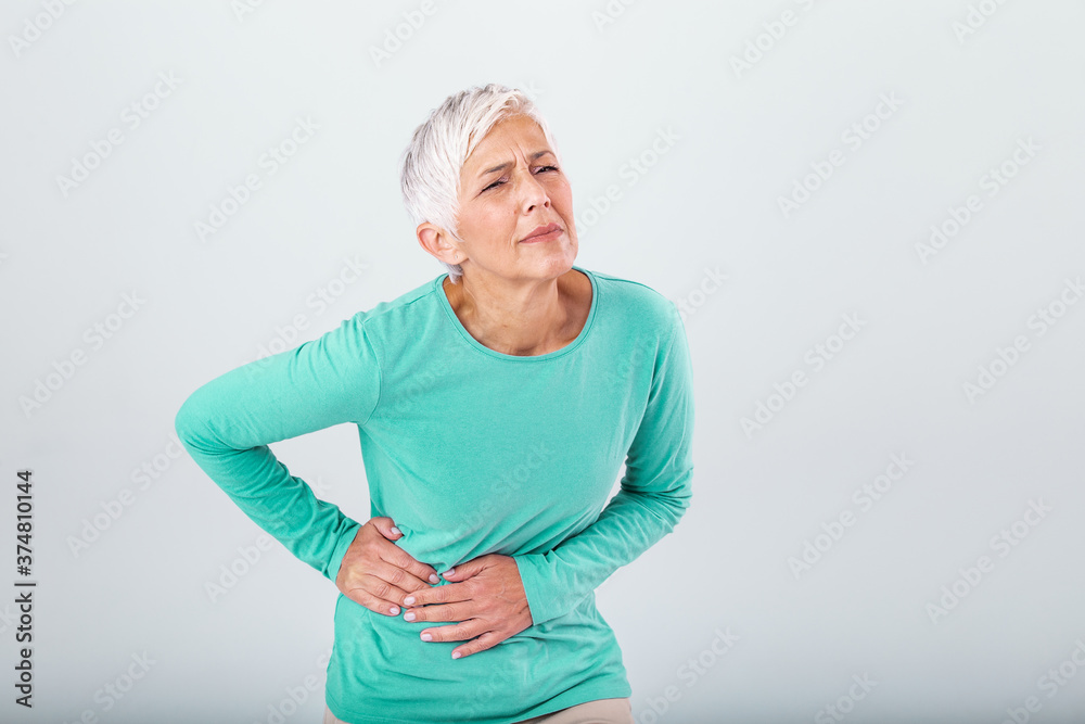 Elderly woman with gray hair touching her aching hip. Upset mature old woman touching back feel hurt osteoarthritis kidney spine ache sore muscles, sad senior lady suffer from lower lumbar pain