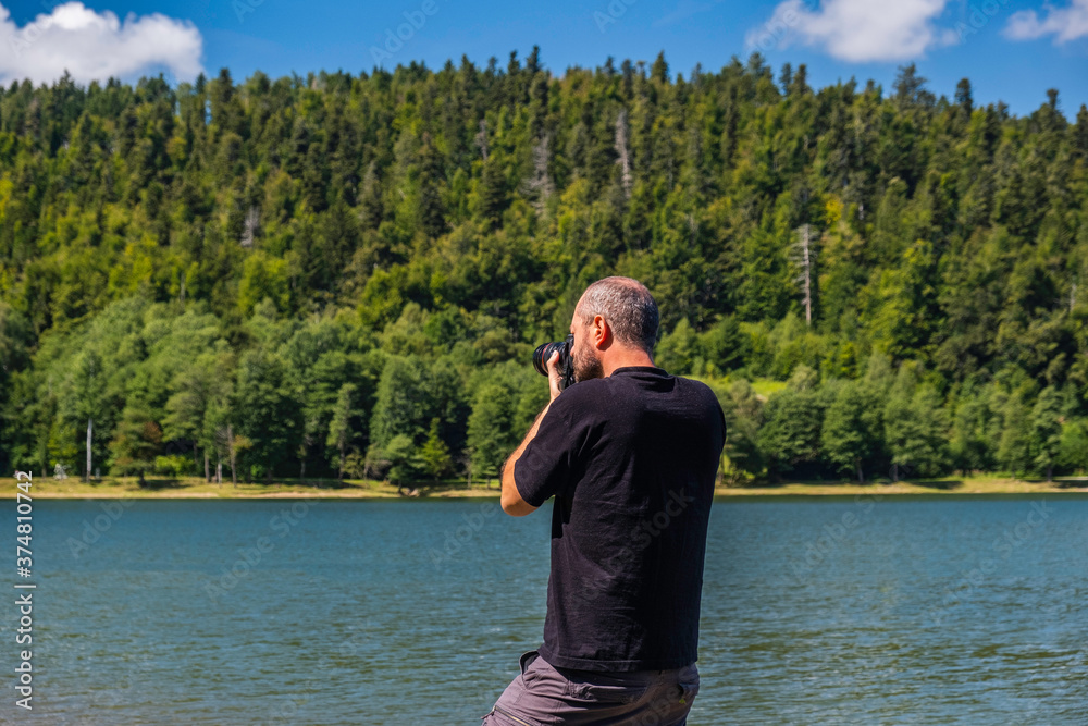Adult man in hoodie walking around lake with DSLR camera ans shooting, beautiful summer day, half body portrait, landscape photography concept
Adult man in hoodie walking around lake with DSLR camera ans shooting, beautiful summer day, half body portrait, landscape photography concept