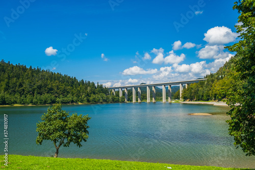 Croatia, Gorski kotar, lake Bajer and highway bridge in Fuzine, mountains and forest in background