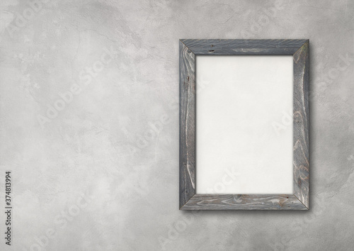 Old rustic wooden picture frame hanging on a concrete wall. Horizontal banner
