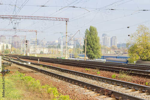 Modern multi-track railway on a background of urban structures