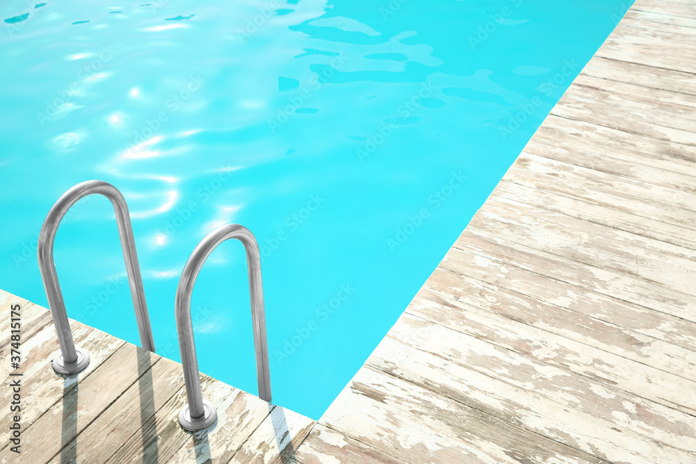Ladder with grab bars in outdoor swimming pool