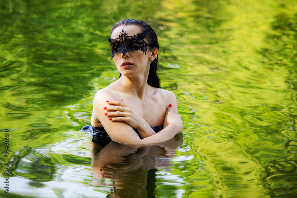 Fototapeta premium wet woman in mask in water