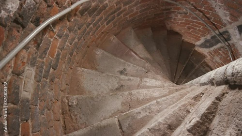 going down the medieval brick and stone staircase