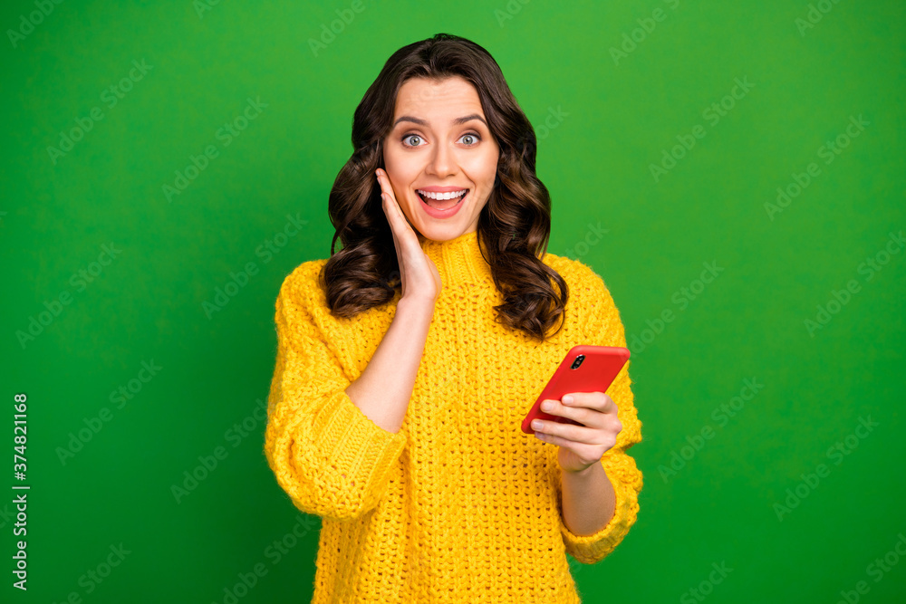 Portrait of energetic cheerful girl use smartphone impressed by social media news scream wow omg wear winter style jumper isolated over bright shine color background Portrait of energetic cheerful girl use smartphone impressed by social media news scream wow omg wear winter style jumper isolated over bright shine color background