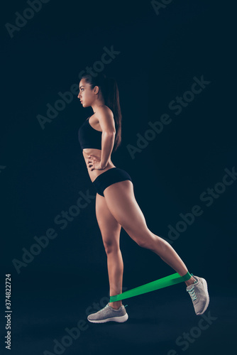 Vertical full length body size profile side view of her she nice-looking attractive sporty perfect adorable slim thin lady doing work out isolated over black background