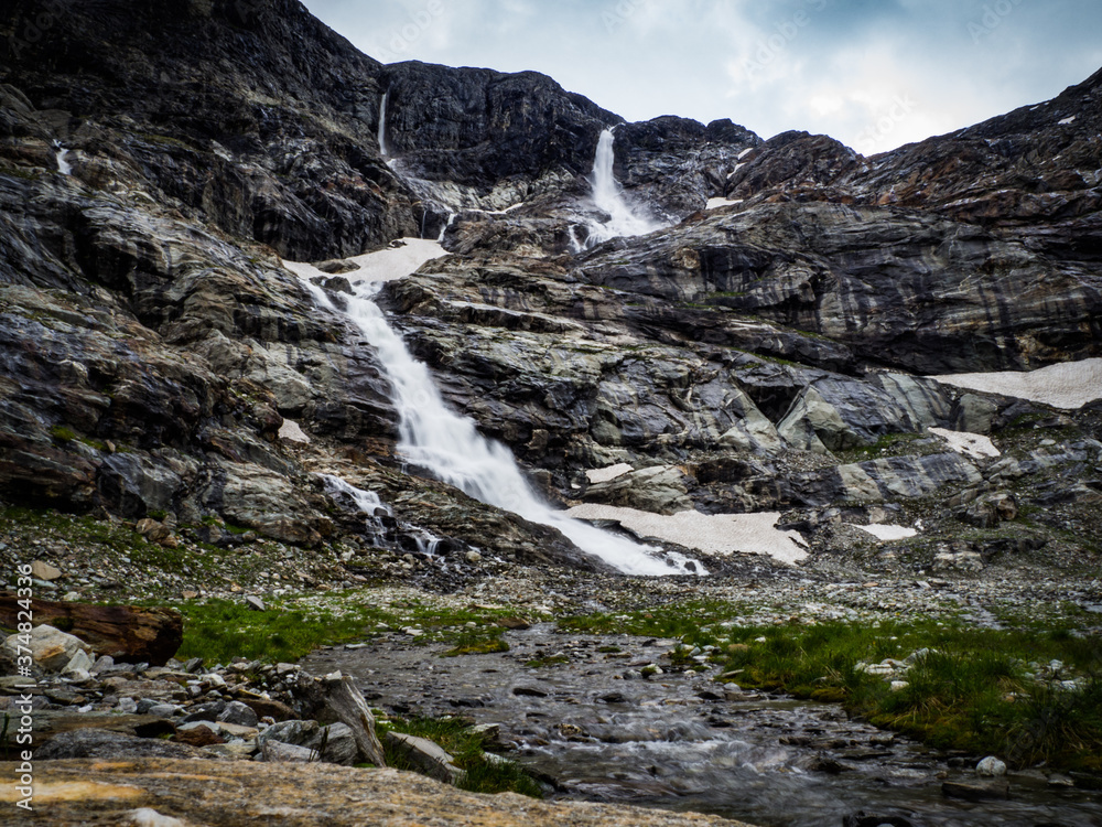 Charming scenery of big waterfalls, wild rivers and picturesque meadows of Alps in National park Hohe Tauern near Kaprun, Austria, Europe.