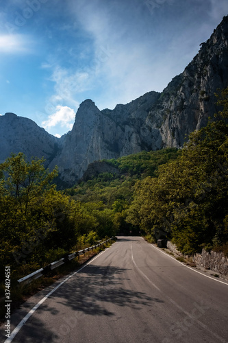 asphalted road in the mountains, beautiful sunshine, summer vacation time © YURII Seleznov