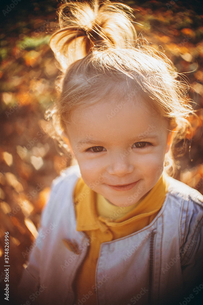 little pretty girl posing for a photo while walking with her parents in autumn park, an infinitely happy and joyful child, selective focus, noise effect little pretty girl posing for a photo while walking with her parents in autumn park, an infinitely happy and joyful child, selective focus, noise effect